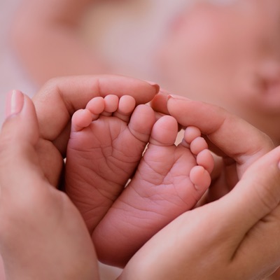 A Mom Touching a Baby's Feet